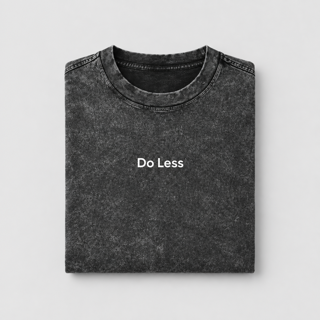 Folded Do Less snow-washed tee on a light-grey background