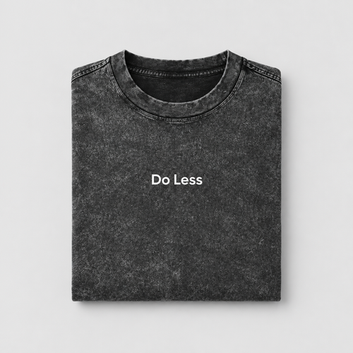 Folded Do Less snow-washed tee on a light-grey background